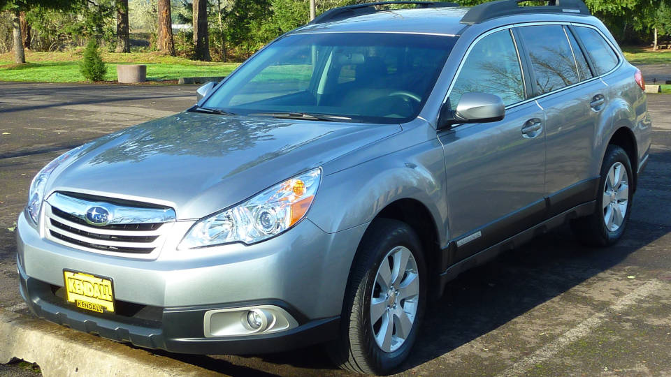 A picture of a used Subaru for sale, parked in a parking lot.